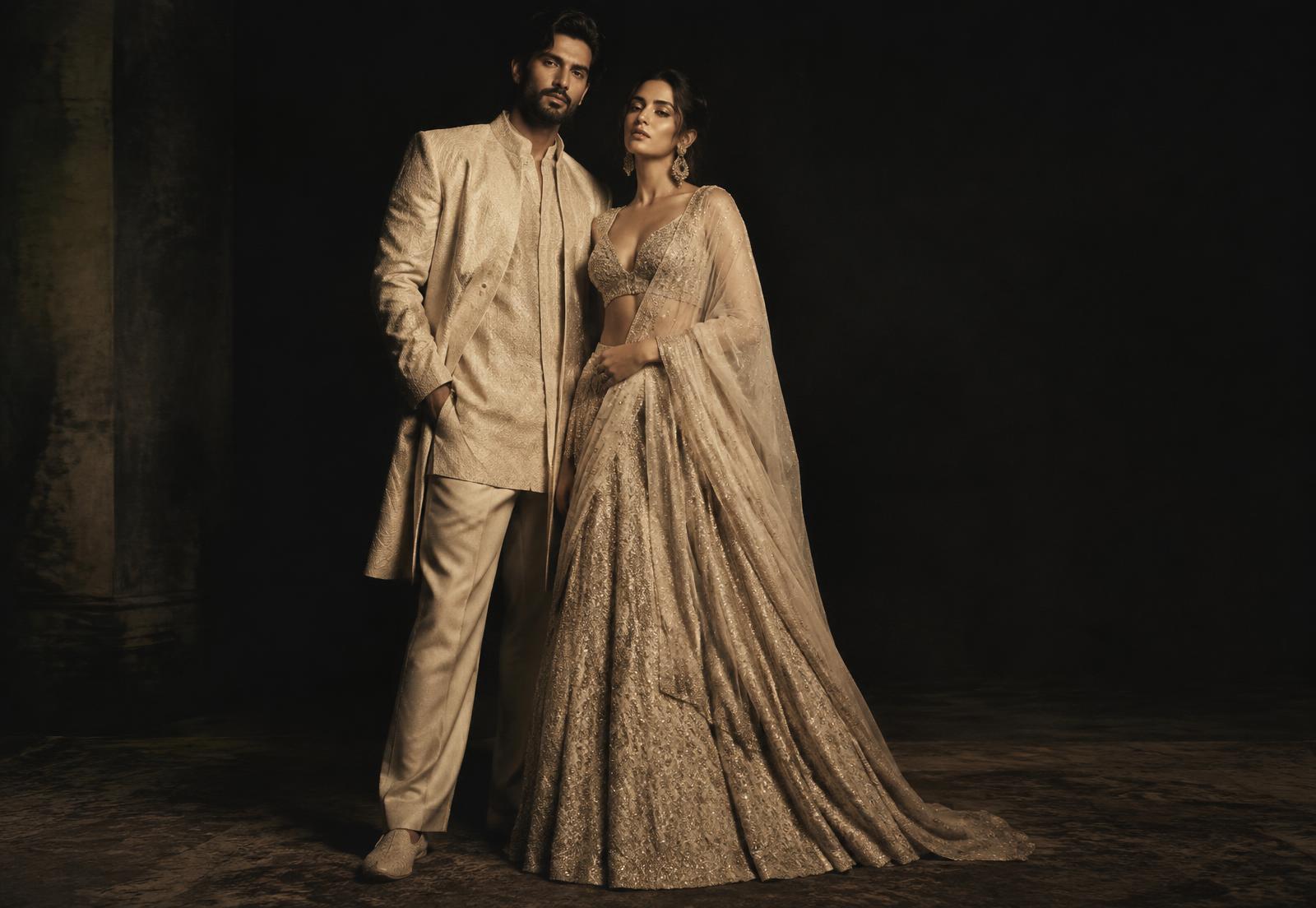 A man and a woman in refined evening fashion, photographed in warm cinematic light